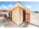 Back exterior of home featuring neutral siding, a small patio and secure fencing at 429 Scenic Dr, Henderson, NV 89002