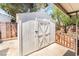 Exterior angle of backyard shed with double doors surrounded by partial landscaping and fencing at 429 Scenic Dr, Henderson, NV 89002