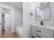Modern bathroom featuring white vanity and marble-look tiled shower and black hardware at 4442 Bennett Dr, Las Vegas, NV 89121