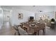 Bright dining area with wood floors adjacent to a living room and featuring a wood dining table at 4442 Bennett Dr, Las Vegas, NV 89121