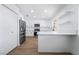 Bright kitchen features white cabinets, stainless appliances, and wood-look flooring at 4442 Bennett Dr, Las Vegas, NV 89121