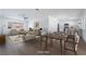Open-concept living space featuring light-colored walls, wood floors, and a dining area adjacent to the kitchen at 4442 Bennett Dr, Las Vegas, NV 89121