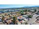 An aerial shot capturing a house in a residential area surrounded by mature trees and mountain views at 4681 Via San Rafael, Las Vegas, NV 89103