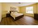 Bedroom with neutral walls, hardwood floors, and a window that lets in natural light at 4681 Via San Rafael, Las Vegas, NV 89103