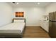 Cozy bedroom featuring wood floors, stainless steel fridge, sink, and simple white decor at 4681 Via San Rafael, Las Vegas, NV 89103