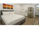 Bright bedroom with a comfy bed, stainless steel fridge, and access to a modern bathroom at 4681 Via San Rafael, Las Vegas, NV 89103