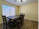 A naturally-lit dining room featuring hardwood floors and a modern light fixture at 4681 Via San Rafael, Las Vegas, NV 89103