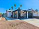 Charming single-story home featuring a modern black and white carport, desert landscaping, and a clear blue sky backdrop at 4681 Via San Rafael, Las Vegas, NV 89103
