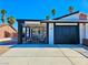 Charming single-story home featuring a modern black and white carport, desert landscaping, and a clear blue sky backdrop at 4681 Via San Rafael, Las Vegas, NV 89103