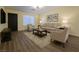Bright living room featuring hardwood floors, neutral furniture, and natural light creating a welcoming atmosphere at 4681 Via San Rafael, Las Vegas, NV 89103