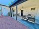 Covered patio with neutral furniture creating a relaxing outdoor living space, alongside low-maintenance landscaping at 4681 Via San Rafael, Las Vegas, NV 89103
