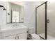A modern bathroom featuring a sleek glass-enclosed shower, elegant fixtures, and bright natural light at 5725 El Royale Ct, Las Vegas, NV 89149