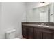 Modern powder room featuring a vanity with dark wood cabinets and a large mirror at 5725 El Royale Ct, Las Vegas, NV 89149
