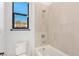 Modern bathroom features a toilet, shower and bathtub combo, and a window offering natural light at 5725 El Royale Ct, Las Vegas, NV 89149