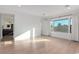 Bright bedroom with light wood flooring, large windows, and an en-suite bathroom at 5725 El Royale Ct, Las Vegas, NV 89149