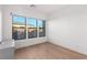 Sunny bedroom with three large windows offering views of the lush outdoor landscape at 5725 El Royale Ct, Las Vegas, NV 89149