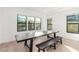 Bright dining room featuring hardwood floors, ample natural light, and a long wooden table at 5725 El Royale Ct, Las Vegas, NV 89149