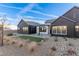 Exterior shot of a modern home featuring desert landscaping, dark accents, and a manicured lawn at 5725 El Royale Ct, Las Vegas, NV 89149