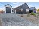 Modern home showcasing a stylish garage and a paved driveway, with desert landscaping at 5725 El Royale Ct, Las Vegas, NV 89149
