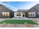 Striking modern home with an inviting entrance, well-manicured grass, and sleek dark accents at 5725 El Royale Ct, Las Vegas, NV 89149