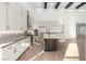Modern kitchen with white cabinetry, stainless steel appliances, and an island with bar seating at 5725 El Royale Ct, Las Vegas, NV 89149