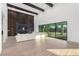 Bright living room with soaring ceilings, modern fireplace, and expansive sliding glass doors at 5725 El Royale Ct, Las Vegas, NV 89149