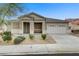 Charming single-story home featuring a well-maintained front yard and a two-car garage at 5833 Craigmore Ln, North Las Vegas, NV 89031