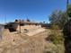 Wide backyard, bench, and mature landscaping awaiting a transformation into a relaxing space at 613 Buchanan Ave, Henderson, NV 89015