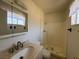 This bathroom has a vanity, toilet, shower, and a window to allow natural lighting to flow into the room at 613 Buchanan Ave, Henderson, NV 89015