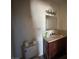 This bathroom features vanity, toilet, and an overhead light ready to be updated to your personal preferences at 613 Buchanan Ave, Henderson, NV 89015