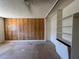Spacious bedroom featuring wood paneling, a closet, and a ceiling fan at 613 Buchanan Ave, Henderson, NV 89015
