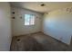 Bedroom features a window for natural light, unique wall decorations, and awaits new flooring at 613 Buchanan Ave, Henderson, NV 89015