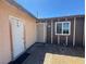 View of front entrance with white storm door and brown window trim at 613 Buchanan Ave, Henderson, NV 89015