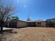 Single-story home featuring a two-car garage and low desert landscaping at 613 Buchanan Ave, Henderson, NV 89015