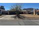 Single-story home featuring a two-car garage and low desert landscaping at 613 Buchanan Ave, Henderson, NV 89015