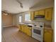 Bright kitchen with tile flooring and yellow cabinets at 613 Buchanan Ave, Henderson, NV 89015