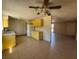 Bright kitchen with tile flooring and yellow cabinets at 613 Buchanan Ave, Henderson, NV 89015
