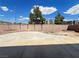 Spacious backyard area with a concrete patio and brick-lined flowerbeds, surrounded by a sturdy brick wall at 7748 Catalina Harbor St, Las Vegas, NV 89131