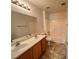Well-lit bathroom featuring a double sink vanity and shower-tub combo at 7748 Catalina Harbor St, Las Vegas, NV 89131