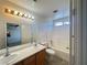 Bright bathroom featuring double sinks, tile floors, and tub-shower combination at 7748 Catalina Harbor St, Las Vegas, NV 89131