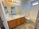 Well-lit bathroom featuring dual sinks, tub, and shower combination at 7748 Catalina Harbor St, Las Vegas, NV 89131