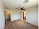 Bedroom featuring neutral carpeting, ceiling fan, and access to a bathroom and closet at 7748 Catalina Harbor St, Las Vegas, NV 89131