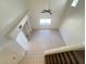 Elevated view of the living room with tile floors, built-in shelving, and abundant natural light at 7748 Catalina Harbor St, Las Vegas, NV 89131