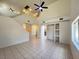 Spacious living room with vaulted ceilings, tile floors, and modern ceiling fan at 7748 Catalina Harbor St, Las Vegas, NV 89131