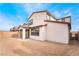 A spacious, dirt backyard, perfect for customization, complements this home's exterior under a bright sky at 785 Black Palace St, Henderson, NV 89011