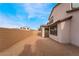 The expansive, dirt backyard, bordered by a brick wall, provides ample space for outdoor living at 785 Black Palace St, Henderson, NV 89011
