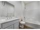 Bathroom features a single sink vanity with stone countertop and a shower-tub combination at 785 Black Palace St, Henderson, NV 89011