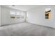 Large carpeted bonus room with multiple windows providing natural light and neighborhood views at 785 Black Palace St, Henderson, NV 89011
