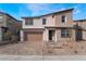 Two-story home with a neutral color palette, attached two-car garage and a charming brick paved driveway at 785 Black Palace St, Henderson, NV 89011