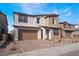 View of the home featuring a two-car garage, covered entryway, and simple landscaping with stone and sparse foliage at 785 Black Palace St, Henderson, NV 89011